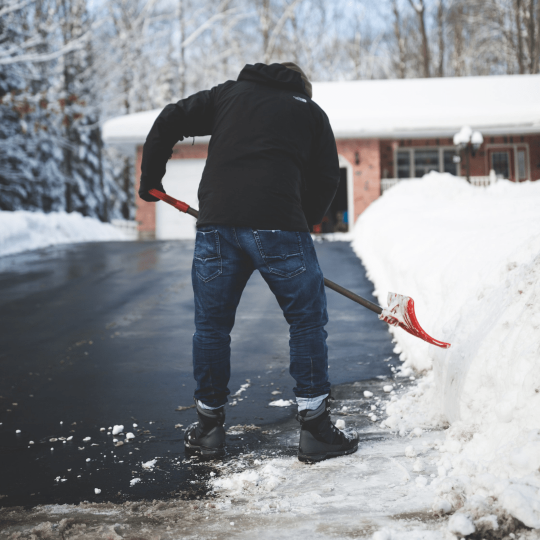 Man Shovelling Snow from Driveway